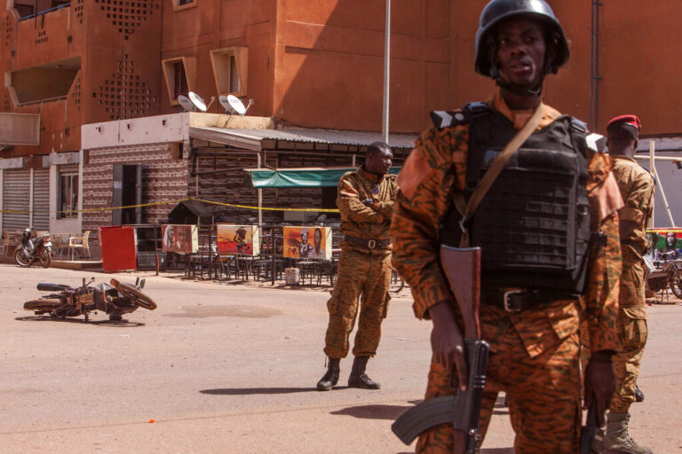 Burkina Faso troops provide security in the area Monday, Jan. 18, 2016, after militants led an attack on a hotel and a cafe popular with foreigners over the weekend in Ouagadougou, Burkina Faso. In the wake of the attack that left over 30 dead, security was beefed up across Burkina Faso's capital Monday as businesses and banks reopened. The West African nation also announced a joint effort with Mali in the fight against jihadi elements in the West African region. (AP Photo/Theo Renaut)