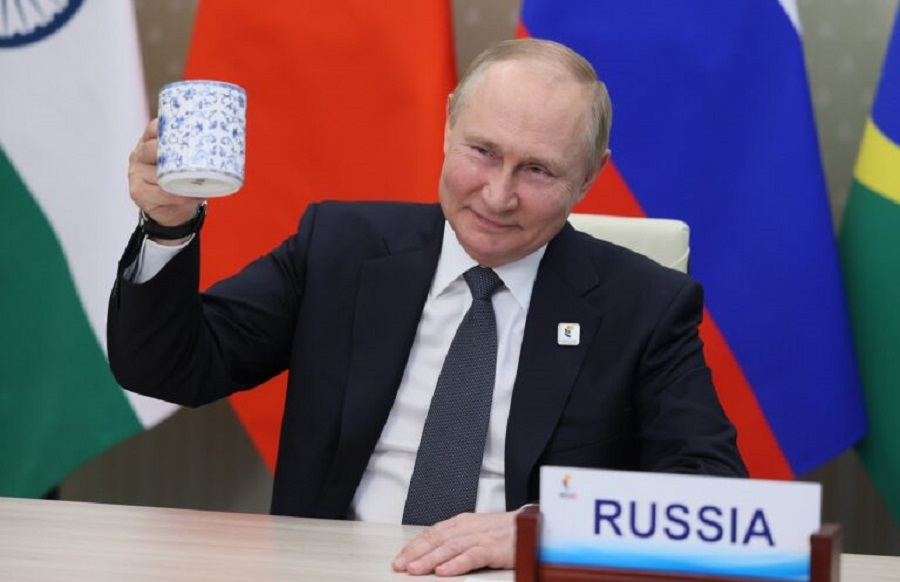 Russian President Vladimir Putin makes a toast as he takes part in a virtual format at the opening ceremony of the BRICS Business Forum via videoconference in Moscow region, in Moscow, Russia, Thursday, June 23, 2022. (Mikhail Metzel/Sputnik, Kremlin Pool Photo via AP)