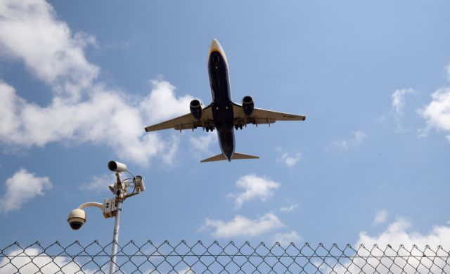 A Ryanair airplane passes a security camera as it lands at Barcelona-El Prat airport