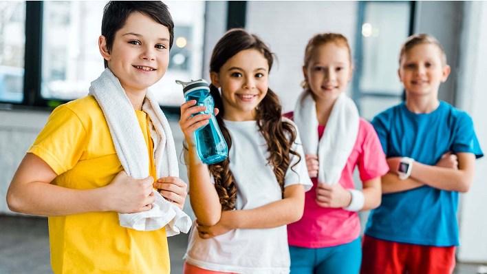 Group of kids with towels posing after training together