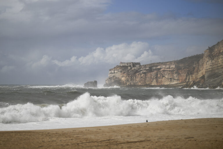 The lighthouse of Nazare is pictured from Nazare beach during the Kirk storm on October 9, 2024. (Photo by PATRICIA DE MELO MOREIRA / AFP)