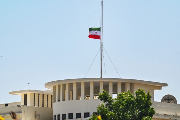 Iran's national flag flies at half mast atop the Iranian Consulate in Karachi on May 20, 2024, in honour of Iranian president Ebrahim Raisi's death in a helicopter crash. Pakistan's Prime Minister Shehbaz Sharif declared a day of mourning after Iranian media reported that president Ebrahim Raisi had died in a helicopter crash. (Photo by Asif HASSAN / AFP)