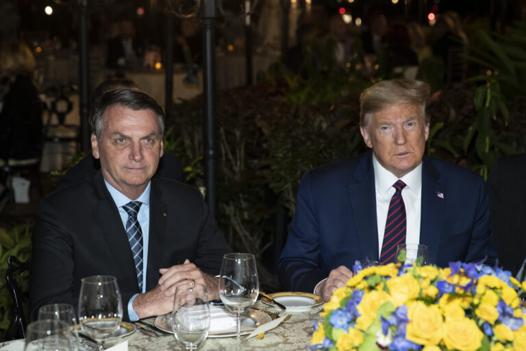 FILE - President Donald Trump is seated before a dinner with Brazilian President Jair Bolsonaro, left, at Mar-a-Lago in Palm Beach, Fla., March 7, 2020. Former President Donald Trump will release a new book next month that features letters from celebrities and politicians written to him through the years. “Letters to Trump” includes letters from the late Democratic Sen. Ted Kennedy and Princess Diana, as well as foreign leaders, including former Brazilian President Jair Bolsonaro and North Korea's Kim Jong Un. (AP Photo/Alex Brandon, File)