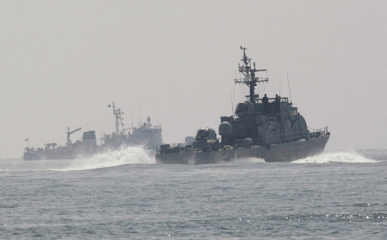 FILE - South Korean Navy's patrol ships search for survivors from the sunken South Korean navy ship near South Korea's Baekryeong island, March 29, 2010. South Korea’s military said Sunday, April 16, 2023, it fired warning shots to repel a North Korean patrol vessel that temporarily crossed the countries’ disputed western sea boundary while chasing a Chinese fishing boat. (AP Photo/Ahn Young-joon, File)