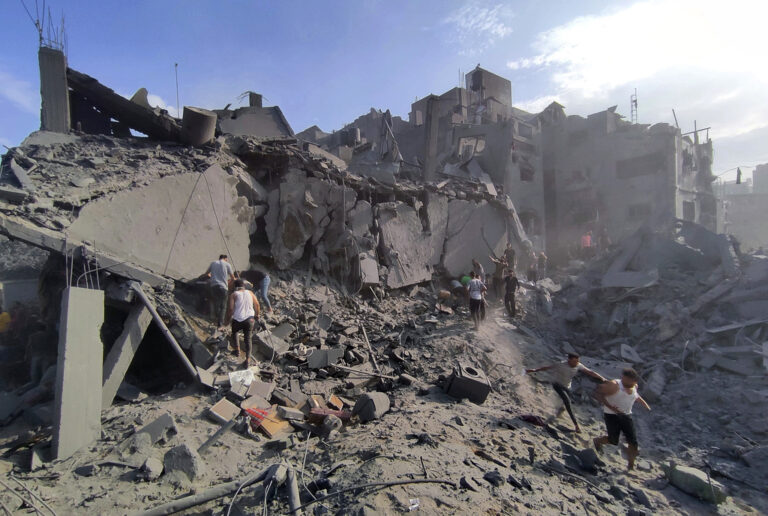 FILE - Palestinians inspect the damage of buildings destroyed by Israeli airstrikes on Jabaliya refugee camp on the outskirts of Gaza City, Tuesday, Oct. 31, 2023.  On Thursday, April 4, 2024, Human Rights Watch says an Israeli attack on a Gaza apartment building in October killed at least 106 civilians, including 54 children.(AP Photo/Abdul Qader Sabbah, ,File)