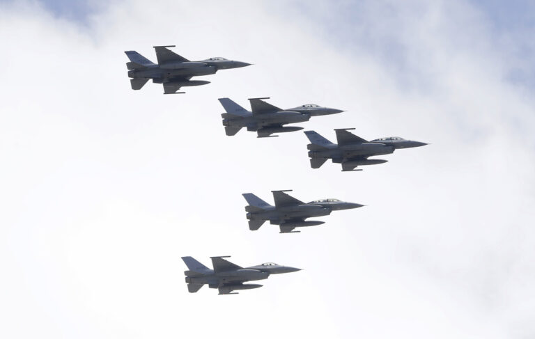 FILE - Taiwan's F-16 fighter jets fly in close formation over President Office during National Day celebrations in front of the Presidential Building in Taipei, Taiwan, Oct. 10, 2021. (AP Photo/Chiang Ying-ying, File)