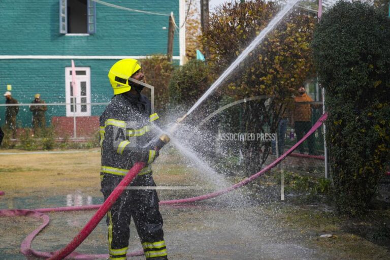 An Indian firefighter works to extinguish a fire on a school building in Srinagar, Indian controlled Kashmir, Thursday, Nov 14, 2024. (AP Photo/Mukhtar Khan)