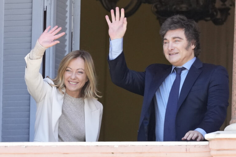 Argentine President Javier Milei and Italy's Prime Minister Giorgia Meloni wave from a government house balcony, in Buenos Aires, Argentina, Wednesday, Nov. 20, 2024. (AP Photo/Natacha Pisarenko)