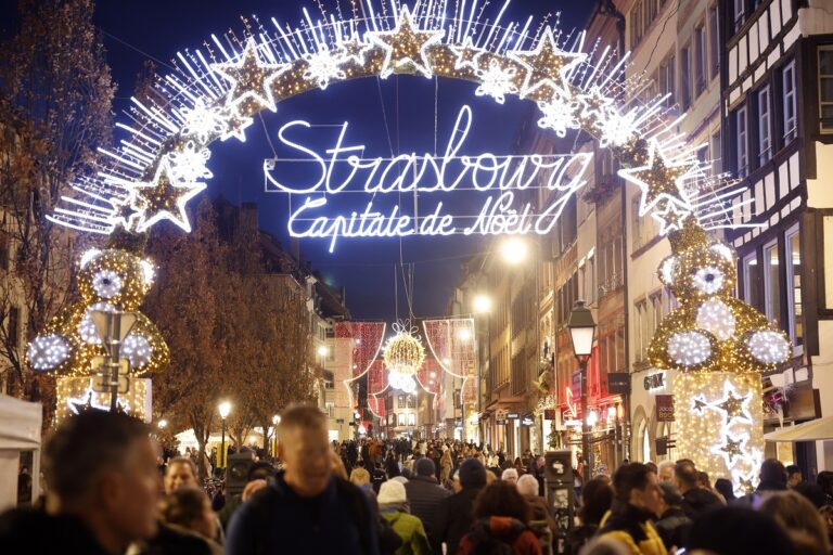 People stroll at the Christmas market that opened Wednesday, Nov. 27, 2024 in Strasbourg, eastern France. (AP Photo/Jean-Francois Badias)