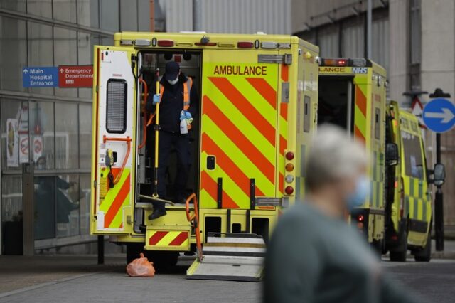 A worker gets out the back of an ambulance after cleaning it following the arrival of a patient in it outside the Royal London Hospital in east London, Thursday, Feb. 4, 2021. The U.K. is under an indefinite national lockdown to curb the spread of the new variant, with nonessential shops, gyms and hairdressers closed, most people working from home and schools largely offering remote learning. (AP Photo/Matt Dunham)