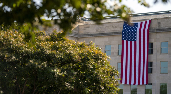 epa11598558 The American flag hangs from the Pentagon during the observance ceremony for the 23rd anniversary of the 9/11 terror attack at the Pentagon in Arlington, Virginia, USA, 11 September 2024. Later in the day, US President Joe Biden and Democratic Presidential nominee Vice President Kamala Harris will lay a wreath at the Pentagon 9/11 Memorial.  EPA/SHAWN THEW