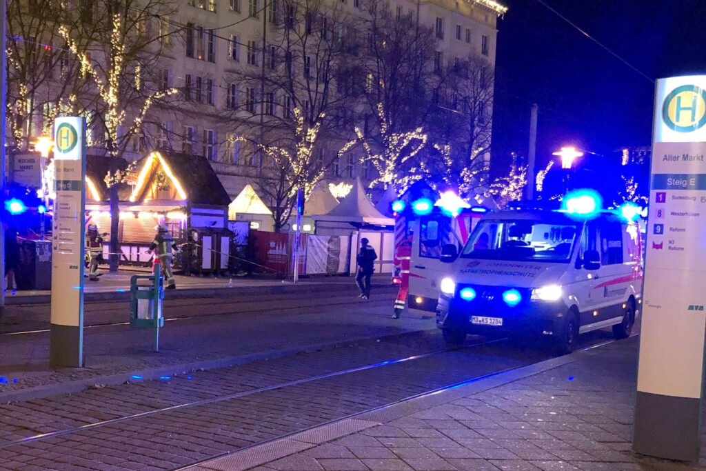 An ambulance stands next to a Christmas market, where a car crashed into a crowd killing and injuring people, according to media, on December 12, 2024 in Magdeburg. (Photo by Doerthe HEIN / dpa / AFP) / Germany OUT