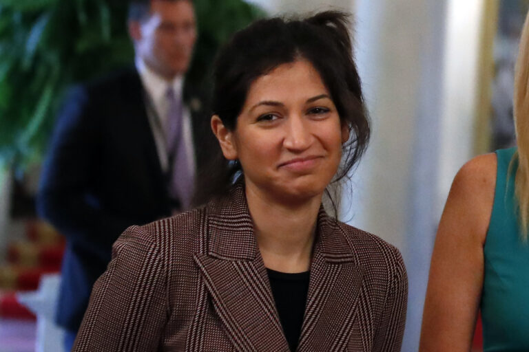 In this April 29, 2020, photo, Katie Miller, press secretary for Vice President Mike Pence, listens as President Donald Trump speaks about reopening the country, during a roundtable with industry executives, in the State Dinning Room of the White House in Washington. Miller has tested positive for coronavirus. (AP Photo/Alex Brandon)