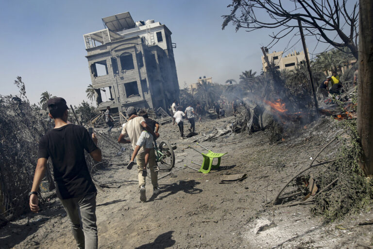 Palestinians evacuate from a site hit by an Israeli bombardment on Khan Younis, southern Gaza Strip, Saturday, July 13, 2024. Israel said it targeted Hamas' shadowy military commander in a massive strike Saturday in the crowded southern Gaza Strip that killed at least 71 people, according to local health officials. Hamas immediately rejected the claim that Mohammed Deif was targeted. (AP Photo/Jehad Alshrafi)