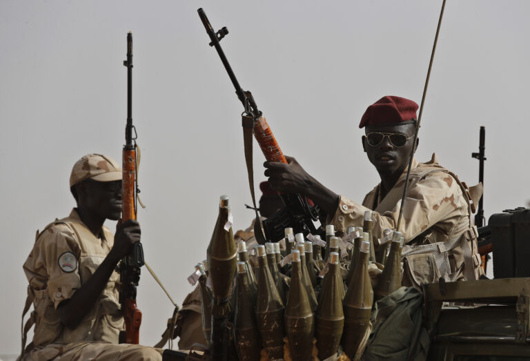 FILE - Sudanese soldiers from the Rapid Support Forces unit, led by Gen. Mohammed Hamdan Dagalo, the deputy head of the military council, secure the area where Dagalo attends a military-backed tribe's rally, in the East Nile province, Sudan, on June 22, 2019. (AP Photo/Hussein Malla, File)