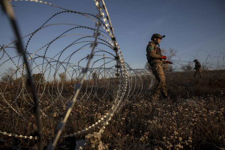 In this photo provided by Ukraine's 24th Mechanised Brigade press service, servicemen of the 24th Mechanised Brigade install anti-tank landmines and non explosive obstacles along the front line near Chasiv Yar town in Donetsk region, Ukraine, Wednesday Oct. 30, 2024. (Oleg Petrasiuk/Ukrainian 24th Mechanised Brigade via AP)