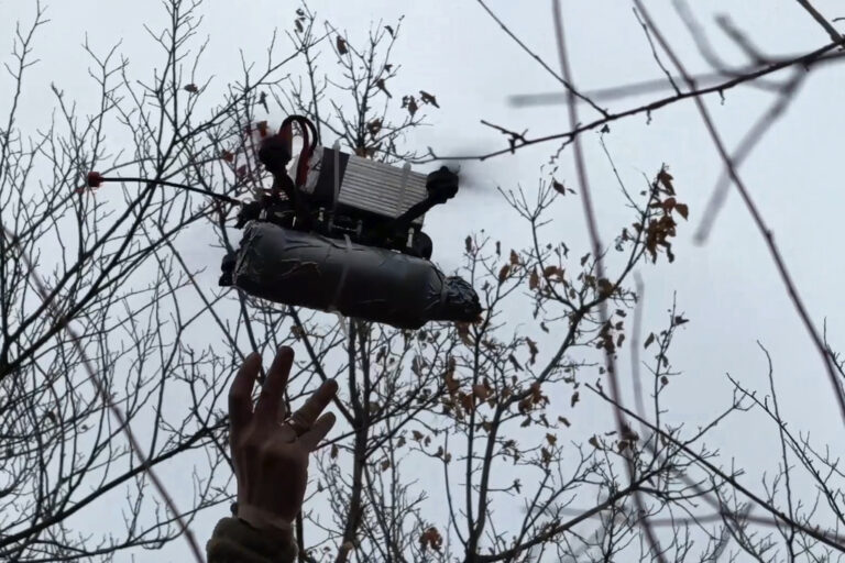 In this photo taken from a video released by Russian Defense Ministry press service on Monday, Nov. 25, 2024, Russian serviceman launches a FPV-drone towards Ukrainian position in an undisclosed location. (Russian Defense Ministry Press Service via AP)