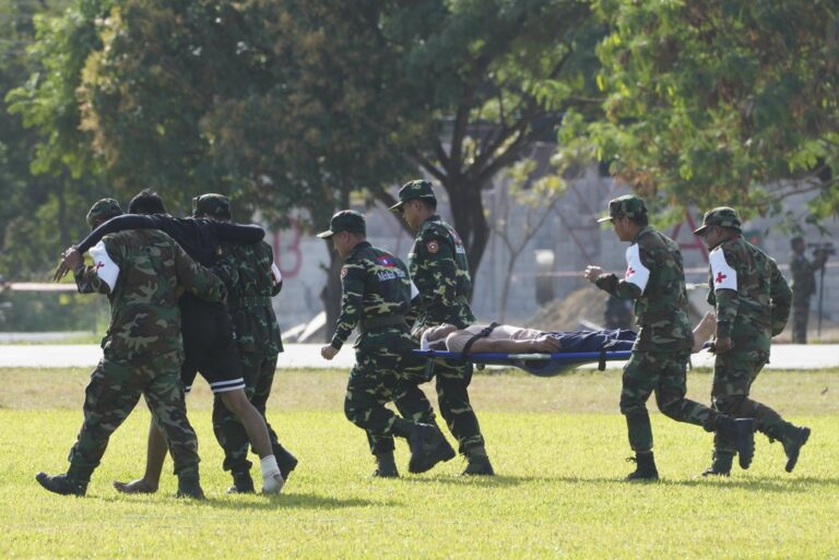 Militaries carry the wounded to rescue them during a drill as they perform for an ending ceremony of militaries joint training exercises between, Cambodia, Laos, and Vietnam, in Svay Chok village, Kampong Chhnang province, north of Phnom Penh Cambodia, Monday, Nov. 25, 2024. (AP Photo/Heng Sinith)