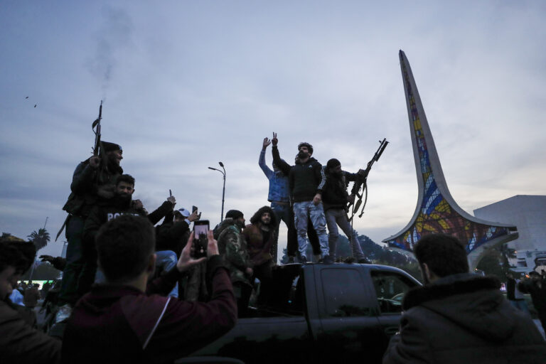 Syrians shoot in the air in celebration of the arrival of opposition fighters in Damascus, Syria, Sunday, Dec. 8, 2024. (AP Photo/Omar Sanadiki)