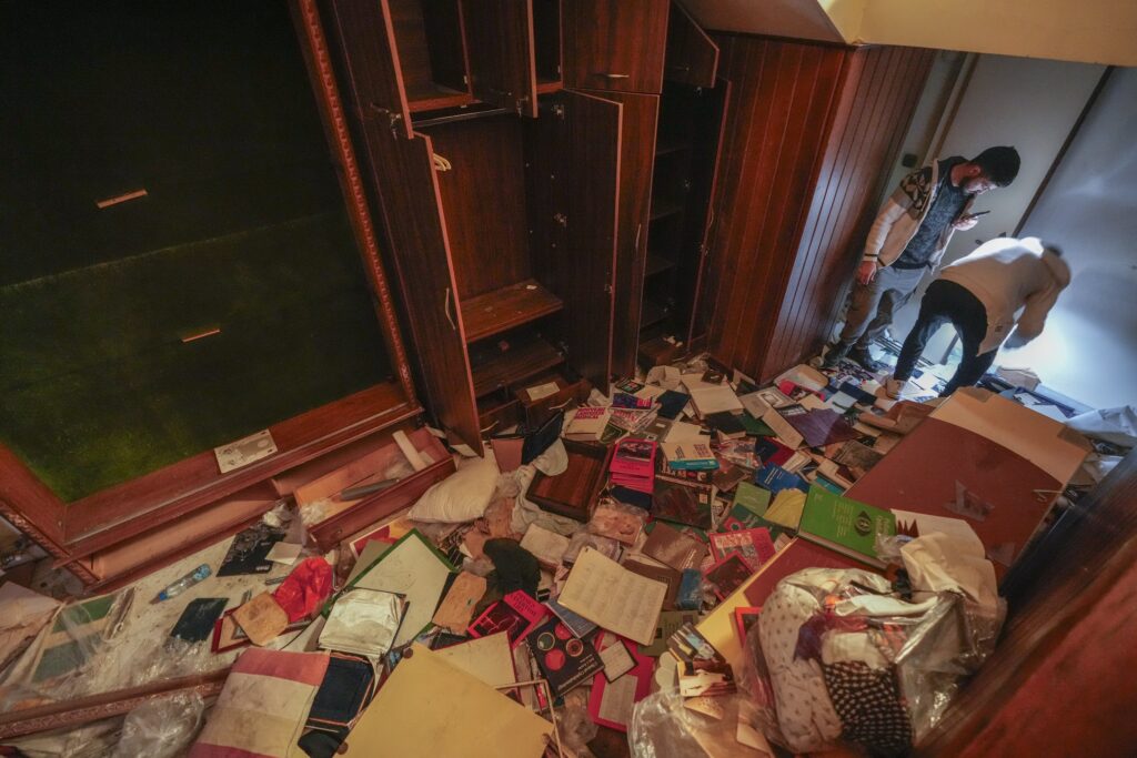 People search for belongings in the ransacked private residence of Syrian President Bashar Assad in the Malkeh district of Damascus, Syria, on Sunday, Dec. 8, 2024. (AP Photo/Hussein Malla)