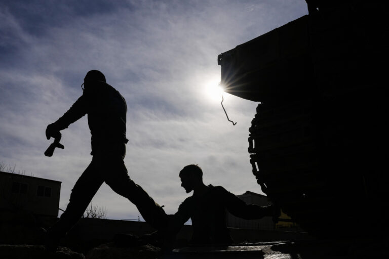 Israeli soldiers load a tank next to the security fence near the so-called Alpha Line that separates the Israeli-annexed Golan Heights from Syria, in the town of Majdal Shams, Wednesday, Dec. 11, 2024. (AP Photo/Matias Delacroix)