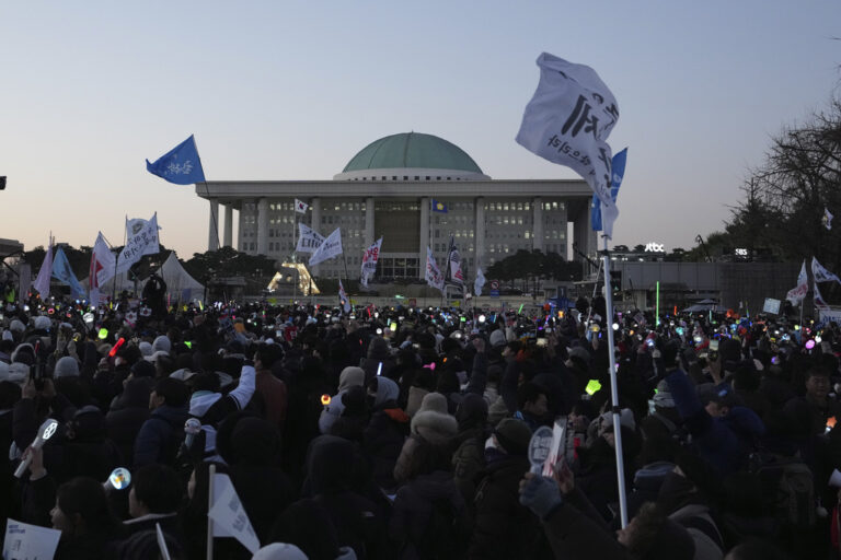 Participants celebrate after hearing the news hearing the news that South Korea's parliament voted to impeach President Yoon Suk Yeol outside the National Assembly in Seoul, South Korea, Saturday, Dec. 14, 2024. (AP Photo/Lee Jin-man)