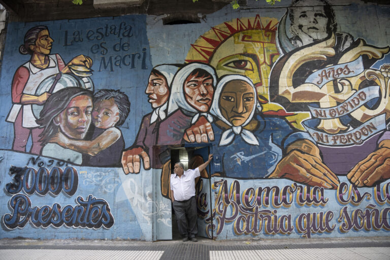 FILE - A mural featuring the Grandmothers of Plaza de Mayo human rights group with a message that reads in Spanish: "30,000 present," in reference to the dissidents who were killed and disappeared during the Pinochet dictatorship, blanket a building in Buenos Aires, Argentina, Tuesday, Dec. 5, 2023. (AP Photo/Victor R. Caivano, File)