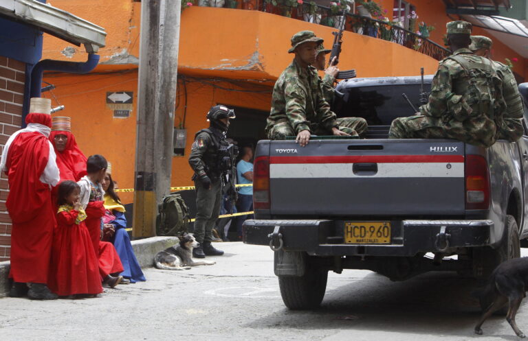 epa10152472 Members of the Colombian National Army patrol the streets of Ituango, in the department of Antioquia, Colombia, 27 August 2022 (Issued 01 September 2022). In Ituango, peace dresses up as utopia. The violence became entrenched more than four decades ago in the beautiful mountains of this rural town in the Colombian department of Antioquia, where the signing of the agreement with the FARC never bore fruit and the construction of a gigantic hydroelectric plant does not appease despair.  EPA/Luis Eduardo Noriega A.