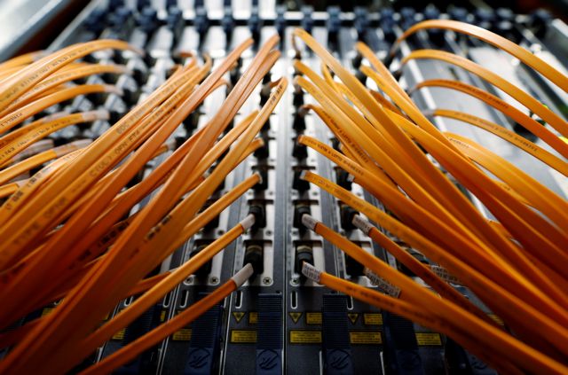 Optical fibre cables of Telecom Italia are seen in a telephone exchange in Rome, Italy December 20, 2013. REUTERS/Alessandro Bianchi/File Photo