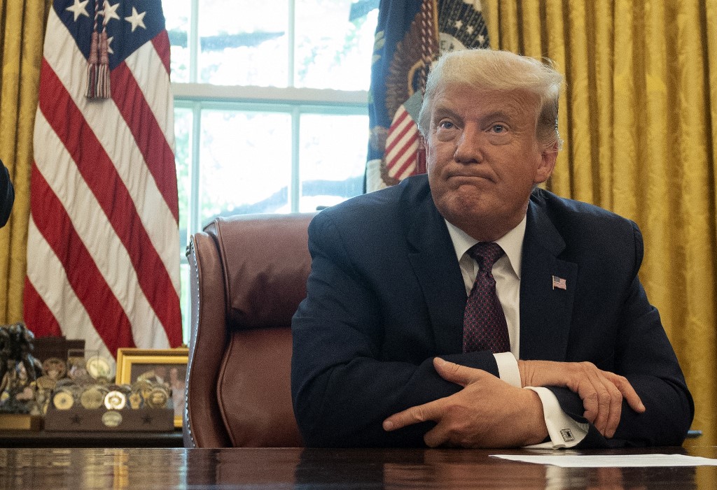 US President Donald Trump listens in the Oval Office of the White House in Washington, DC, on September 11, 2020. Trump announced Friday a "peace deal" between Israel and Bahrain, which becomes the second Arab country to settle with its former foe in the last few weeks. (Photo by ANDREW CABALLERO-REYNOLDS / AFP)