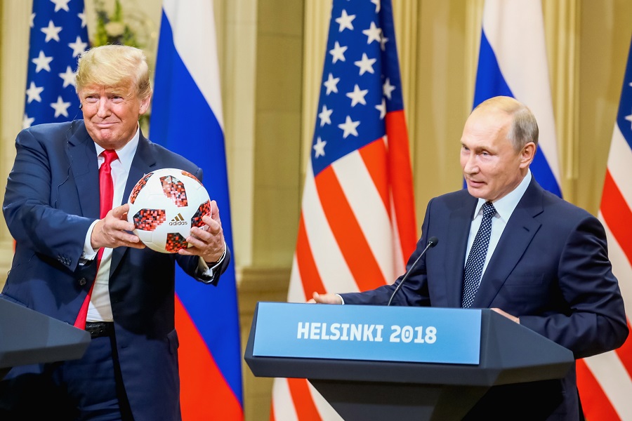 epa06893318 US President Donald J. Trump (L) receivs a soccer ball of the 2018 FIFA World Cup from Russian President Vladimir Putin (R) during a joint press conference in the Hall of State at Presidential Palace following their summit talks, in Helsinki, Finland, 16 July 2018.  EPA/MAURI RATILAINEN