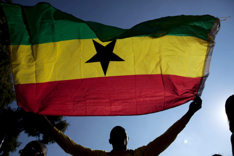 A Ghana fans waves a flag outside the Loftus Versfeld Stadium in Pretoria,  Sunday, June 13, 2010, prior to a World Cup group D soccer match between Serbia and Ghana.(AP Photo/Guillermo Arias)