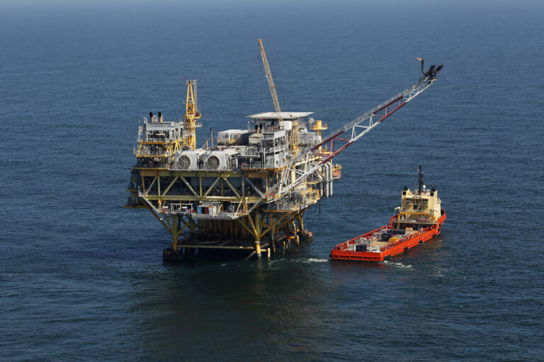 FILE - This April 10, 2011, file photo, shows a rig and supply vessel in the Gulf of Mexico, off the coast of Louisiana.  The Biden administration on Friday proposed up to three oil and gas lease sales in the Gulf of Mexico over the next five years — and none in Alaska — as it tries to navigate between energy companies that have pressed for greater oil and gas production and environmental activists who have urged President Joe Biden to shut down new offshore drilling in the fight against climate change.   (AP Photo/Gerald Herbert, File)