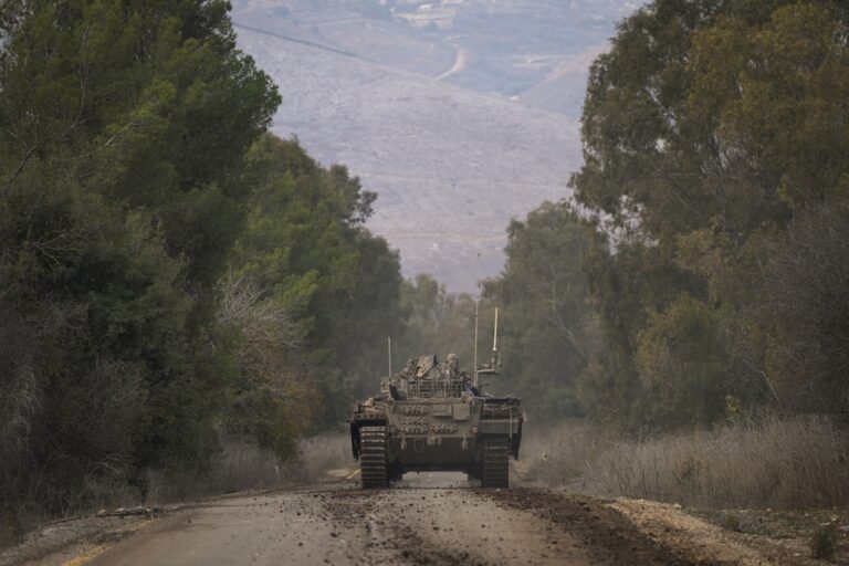 An Israeli army armoured vehicle drives along a road near the agricultural settlement of Avivim, next to the Lebanese border in northern Galilee, Israel, Thursday Nov 28, 2024. (AP Photo/Ohad Zwigenberg)