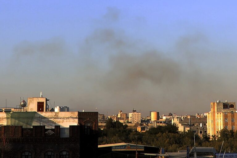 Smoke rises from the area around the International Airport following an airstrike, as seen from Sanaa, Yemen, Thursday, Dec. 26, 2024. The Israeli military reported targeting infrastructure used by the Houthis at the Sanaa International Airport, as well as ports in Hodeida, Al-Salif, and Ras Qantib, along with power stations.(AP Photo/Osamah Abdulrahman)