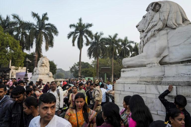 People gather around the entrance of Victoria Memorial garden as they celebrate the New Year in Kolkata, India, Wednesday, Jan. 1, 2025. (AP Photo/Bikas Das)