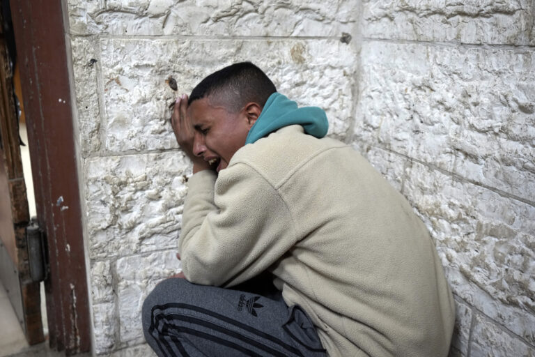 A man mourns the death of his relatives at Al-Aqsa Martyrs Hospital following Israeli army airstrikes in Deir al-Balah, central Gaza Strip, Saturday, Jan. 4, 2025. (AP Photo/Abdel Kareem Hana)