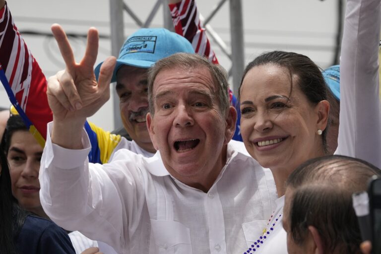 FILE - Former diplomat Edmundo González Urrutia flashes a V hand sign accompanied by opposition leader Mariana Corina Machado, as he kicks off his presidential campaign, in La Victoria, Venezuela, May 18, 2024. González asked supporters to imagine "a country in which our airports and borders would be filled with our children returning home" should he win. (AP Photo/Ariana Cubillos, File)