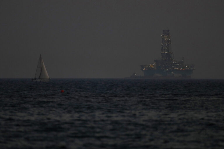 FILE - An offshore drilling rig is seen in the waters off Cyprus' coastal city of Limassol, on July 5, 2020 as a sailboat sails in the foreground. The Cyprus government has given U.S. energy company Chevron another six months to come up with a revised plan to develop a sizeable natural gas deposit off the island nation's southern coastline after an earlier plan was deemed to lack a specific timetable, an official said Thursday, May 2, 2024. (AP Photo/Petros Karadjias, File)