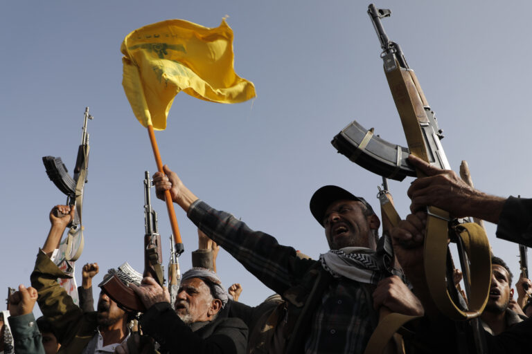 Houthi supporters raise a Hezbollah flag during an anti-Israel and anti-U.S. rally in Sanaa, Yemen, Friday, Sept. 27, 2024. (AP Photo/Osamah Abdulrahman)