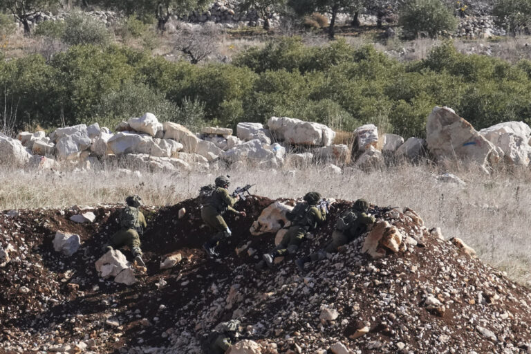 Israeli soldiers take position near the so-called Alpha Line that separates the Israeli-annexed Golan Heights from Syria, in the town of Majdal Shams, Monday, Dec. 9, 2024. (AP Photo/Matias Delacroix)