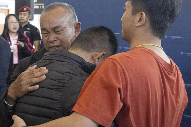 A Thai hostage who was freed from Hamas, Pongsak Thaenna, center, hugs a relative upon arrival at Suvarnabhumi International Airport, in Samut Prakarn Province, Thailand, Sunday, Feb. 9, 2025. (AP Photo/Wason Wanichakorn)