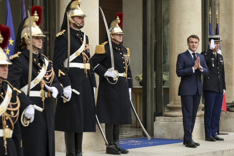 French President Emmanuel Macron waits on the arrival of United States Vice-President JD Vance and second lady Usha Vance for a working lunch at the Elysee Palace during an event on the sidelines of the Artificial Intelligence Action Summit in Paris, Tuesday, Feb. 11, 2025. (AP Photo/Thomas Padilla)