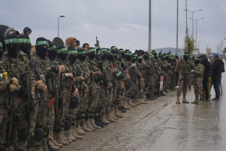 CORRECTS THE NAME OF THE CITY AS NUSEIRAT - Hamas fighters stand in formation ahead Israeli hostages release in Nuseirat, Gaza Strip, Saturday, Feb. 22, 2025. (AP Photo/Abdel Kareem Hana)