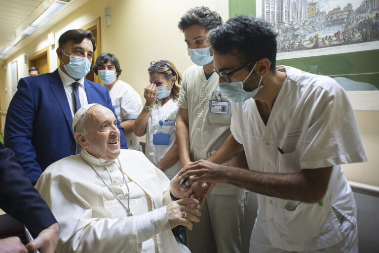 FILE - Pope Francis is greeted by hospital staff as he sits in a wheelchair inside the Agostino Gemelli Polyclinic in Rome, Sunday, July 11, 2021, where he was hospitalized for intestine surgery. (Vatican Media via AP, file)