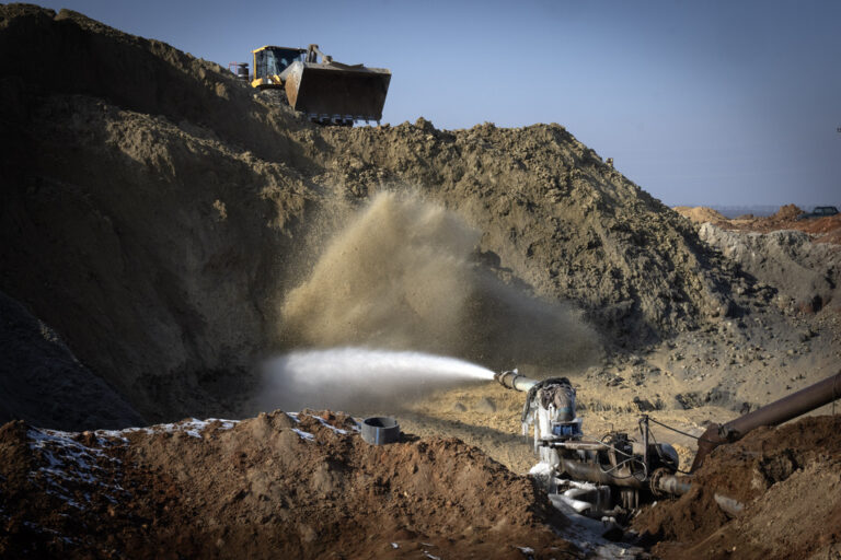 Miners extract ilmenite, a key element used to produce titanium, at an open pit mine in the central region of Kirovohrad, Ukraine, Wednesday, Feb. 12, 2025. (AP Photo/Efrem Lukatsky)