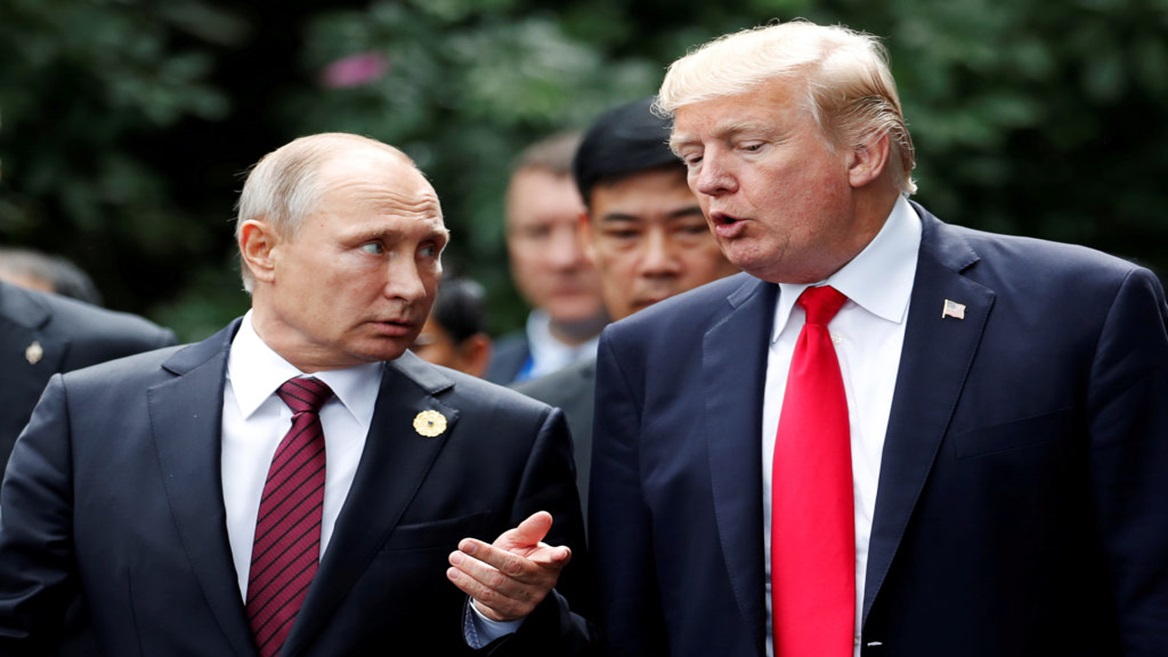 FILE PHOTO: U.S. President Donald Trump and Russia's President Vladimir Putin talk during the family photo session at the APEC Summit in Danang, Vietnam November 11, 2017. REUTERS/Jorge Silva/File Photo - RC1287F1C9B0