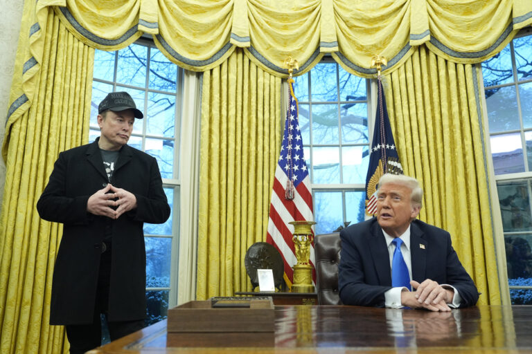 President Donald Trump listens as Elon Musk speaks in the Oval Office at the White House, Tuesday, Feb. 11, 2025, in Washington. (AP Photo/Alex Brandon)