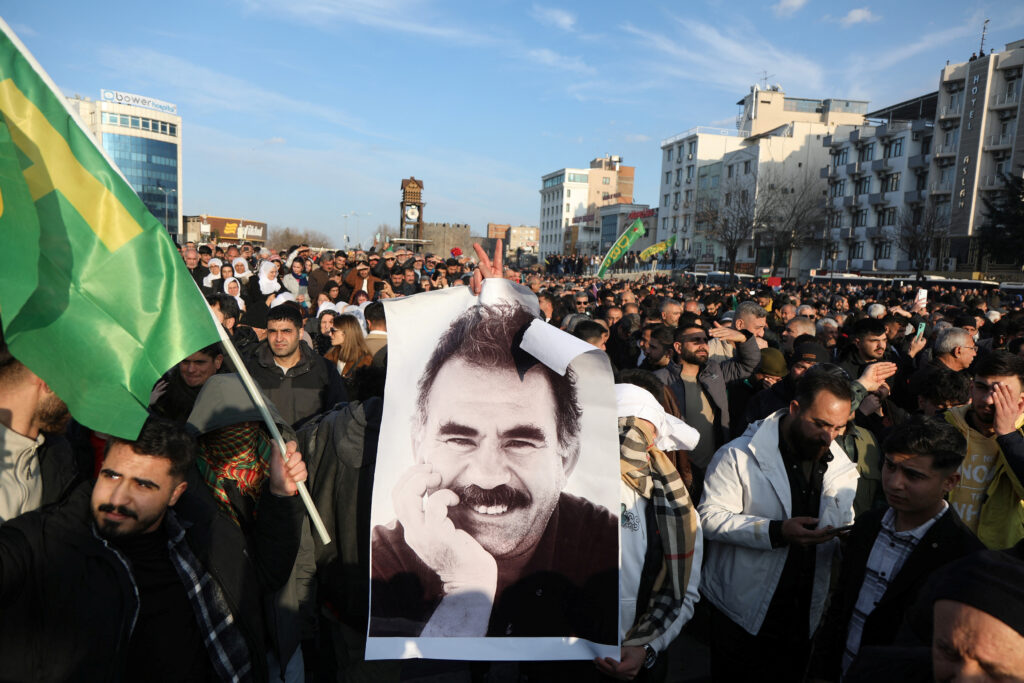 A demonstrator holds a picture of jailed Kurdish militant leader Abdullah Ocalan during a rally in Diyarbakir, Turkey, February 27, 2025. REUTERS/Sertac Kayar